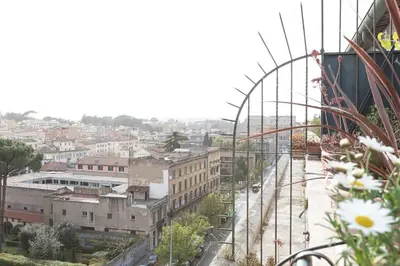 a view of a city with a roller coaster at Colosseo Terrace Apartment in Rome