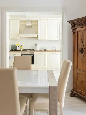 a kitchen with a white table and chairs at FCR Rome Apartments Gracchi Vatican in Rome