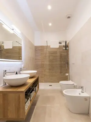 a bathroom with two sinks and a toilet and a shower at FCR Rome Apartments Gracchi Vatican in Rome