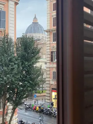 a view from a window of a city street with motorcycles at FCR Rome Apartments Gracchi Vatican in Rome