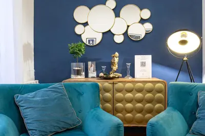 a blue living room with a blue couch and a table at Amazing Art Déco Apartment Pantheon in Rome