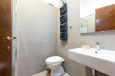 a bathroom with a toilet and a sink at Amazing Art Déco Apartment Pantheon in Rome
