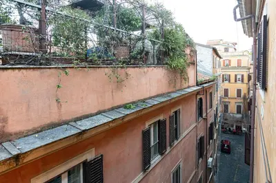 an apartment building with plants growing on the side of it at Amazing Art Déco Apartment Pantheon in Rome