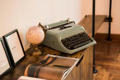an old typewriter sitting on top of a wooden table at Appartamento Principe Amedeo in Rome