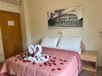 a hotel room with a bed with roses on it at Palazzo Sant'Antonio in Rome