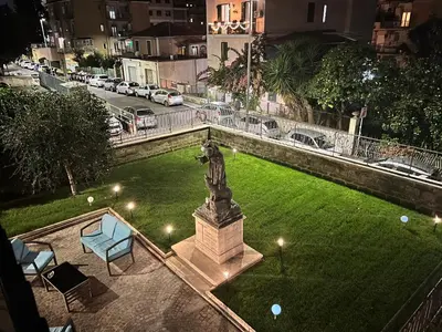 a statue in the middle of a field of grass at Palazzo Sant'Antonio in Rome