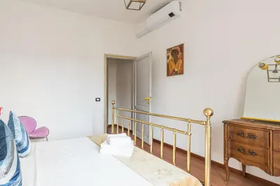 a bedroom with a bed and a dresser at Stylish Pigneto Apartment in Rome