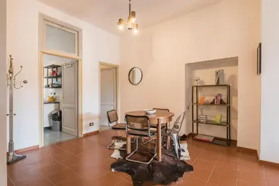 a dining room with a table and chairs in a room at Stylish Pigneto Apartment in Rome