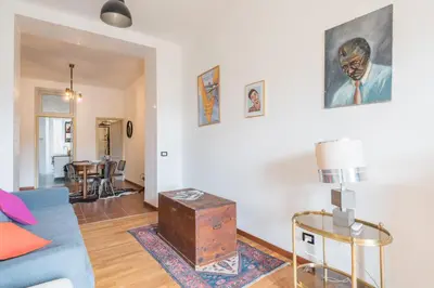 a living room with a blue couch and a table at Stylish Pigneto Apartment in Rome