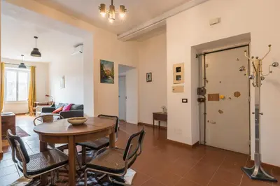 a living room with a table and chairs at Stylish Pigneto Apartment in Rome