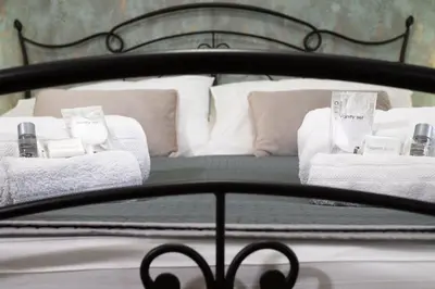 a bed with white towels and pillows on it at Residenza Lualdi in Rome