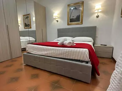 a bedroom with a bed with a stuffed animal on it at Center Apartments vittorio Emanuele in Rome