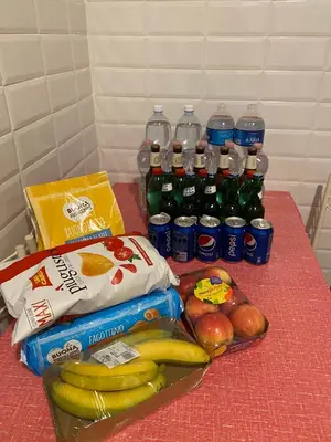 a table with a bunch of bottles of soda and fruit at Center Apartments vittorio Emanuele in Rome