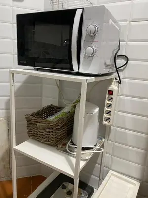 a microwave on a white shelf with a toaster oven at Center Apartments vittorio Emanuele in Rome