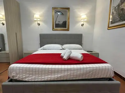 a bedroom with a bed with two towels on it at Center Apartments vittorio Emanuele in Rome