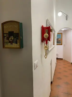 a hallway with a red phone on a wall at Center Apartments vittorio Emanuele in Rome