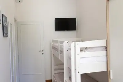 a bedroom with a bunk bed and a tv on the wall at Pantheon Magic House in Rome
