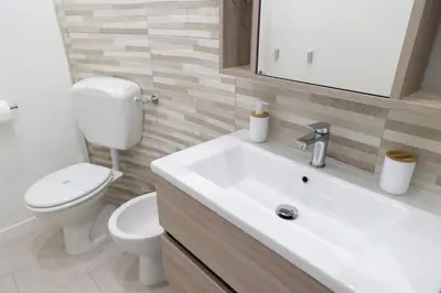 a bathroom with a white sink and a toilet at Pantheon Magic House in Rome