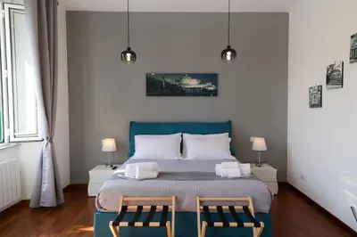 a bedroom with a blue bed and two chairs at Pantheon Magic House in Rome