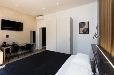 a bedroom with a bed and a desk and a table at KOSMO ROME Luxury in Rome