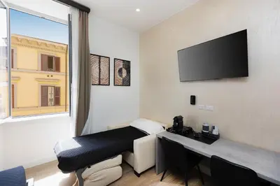 a room with a desk and a tv on the wall at KOSMO ROME Luxury in Rome