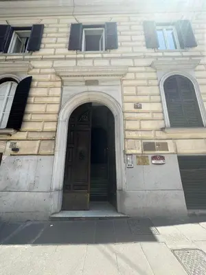 a building with a brown door and two windows at KOSMO ROME Luxury in Rome