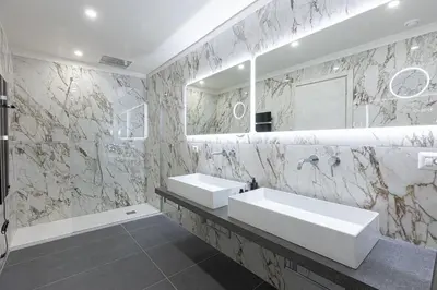 a bathroom with two sinks and a mirror at KOSMO ROME Luxury in Rome