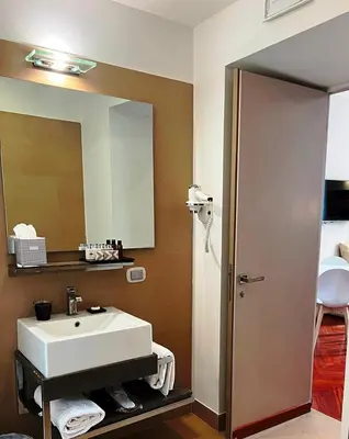 a bathroom with a white sink and a mirror at Dolce Vita Guest House in Rome