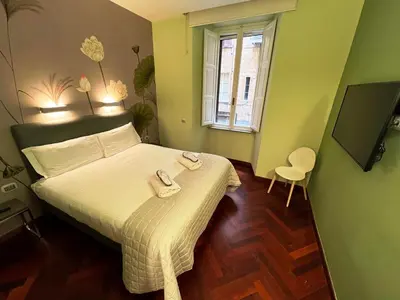 a bedroom with a bed with two towels on it at Dolce Vita Guest House in Rome