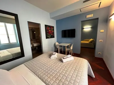 a bedroom with a bed and a table in it at Dolce Vita Guest House in Rome