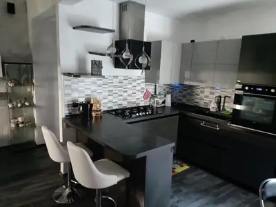 a kitchen with a black counter and white appliances at Nathan House,Teano in Rome