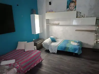 a small room with two beds and a baby in it at Nathan House,Teano in Rome