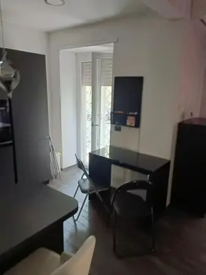 a living room with a black table and chairs at Nathan House,Teano in Rome