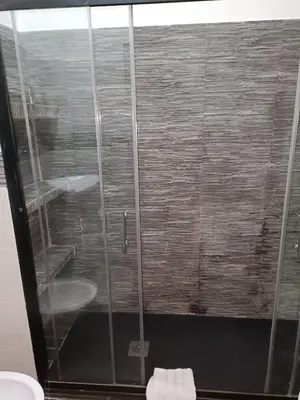 a bathroom with a shower with a toilet and a sink at Nathan House,Teano in Rome