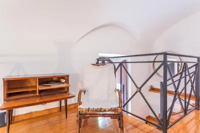 a desk and a chair in a room with a desk at Trastevere Vintage Artistic Loft in Rome