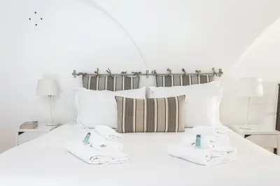 a white bed with two white towels on it at Trastevere Vintage Artistic Loft in Rome