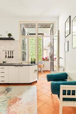 a kitchen with a sink and a living room at R.C. Cappellari Loft Campo de' Fiori in Rome