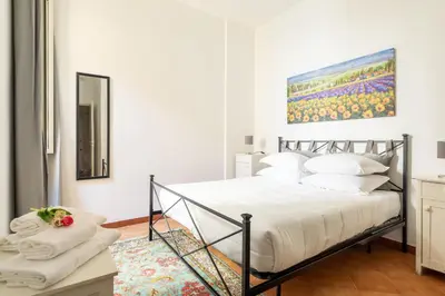 a bedroom with a bed and a painting on the wall at R.C. Cappellari Loft Campo de' Fiori in Rome