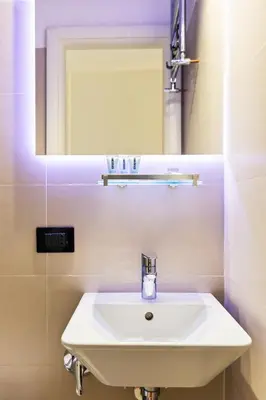 a white sink in a bathroom with a mirror at R.C. Cappellari Loft Campo de' Fiori in Rome