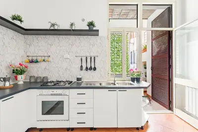 a kitchen with white cabinets and a sink at R.C. Cappellari Loft Campo de' Fiori in Rome
