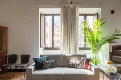 a living room with a couch and a large window at iFlat Lovely flat in Navona in Rome