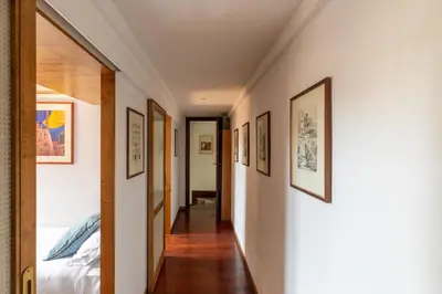 a hallway with pictures on the walls of a bedroom at iFlat Lovely flat in Navona in Rome