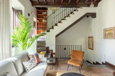 a living room with a couch and a staircase at iFlat Lovely flat in Navona in Rome