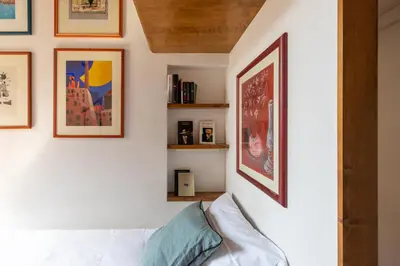 a living room with a white couch and pictures on the wall at iFlat Lovely flat in Navona in Rome