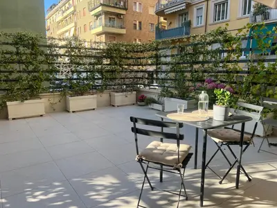 a patio with a table and chairs on a balcony at B&B Lungotevere Flaminio in Rome