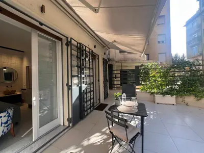 a patio with tables and chairs in front of a building at B&B Lungotevere Flaminio in Rome