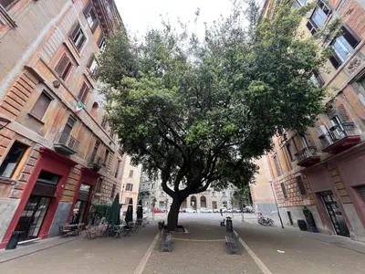 a group of tables and chairs with umbrellas in front of a building at B&B Lungotevere Flaminio in Rome