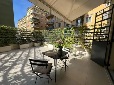 a patio with a table and chairs on a balcony at B&B Lungotevere Flaminio in Rome