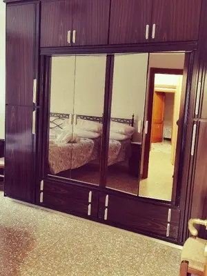 a large glass cabinet with a reflection of a bed in it at Appartamento per Turisti e Famiglie Roma in Rome