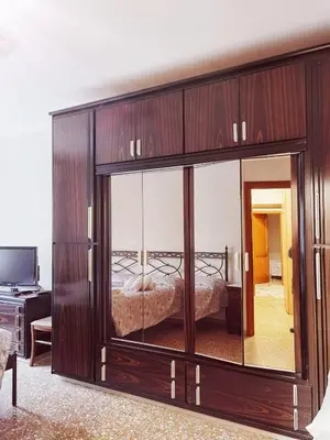 a large wooden cabinet with a bed in a room at Appartamento per Turisti e Famiglie Roma in Rome